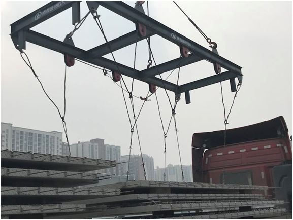 指挥塔吊缓慢收绳,通过吊具滑轮组使叠合板受力平衡,并再次检查挂钩